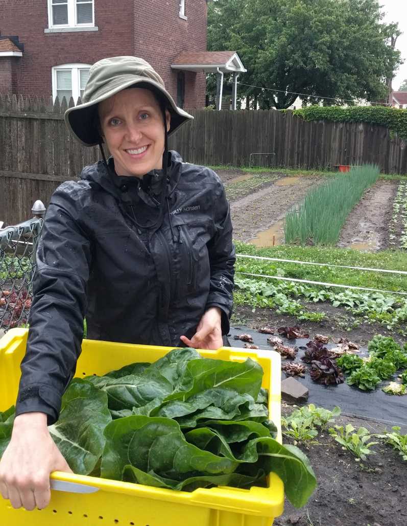 Annabel holding a yellow tote of chard leaves
